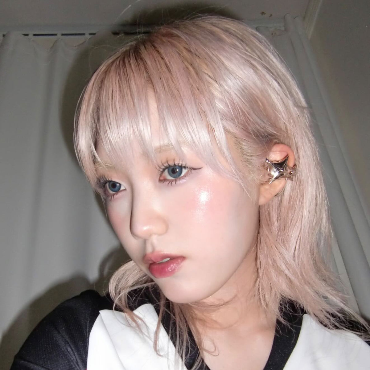 NEBULA ear-hook earphones paired with a black-and-white neckline.