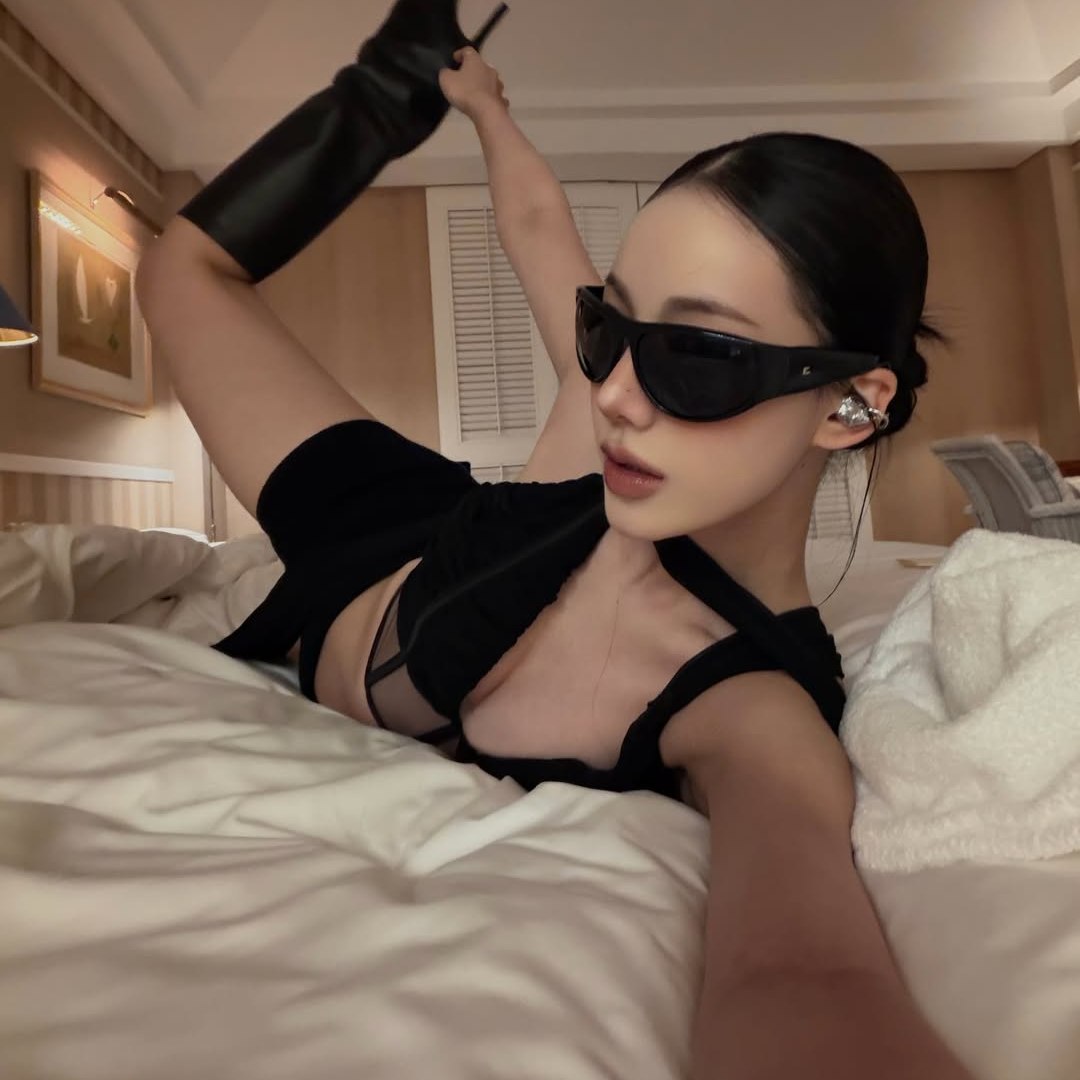 Electronic Gems styled with a black neckline and dark sunglasses.