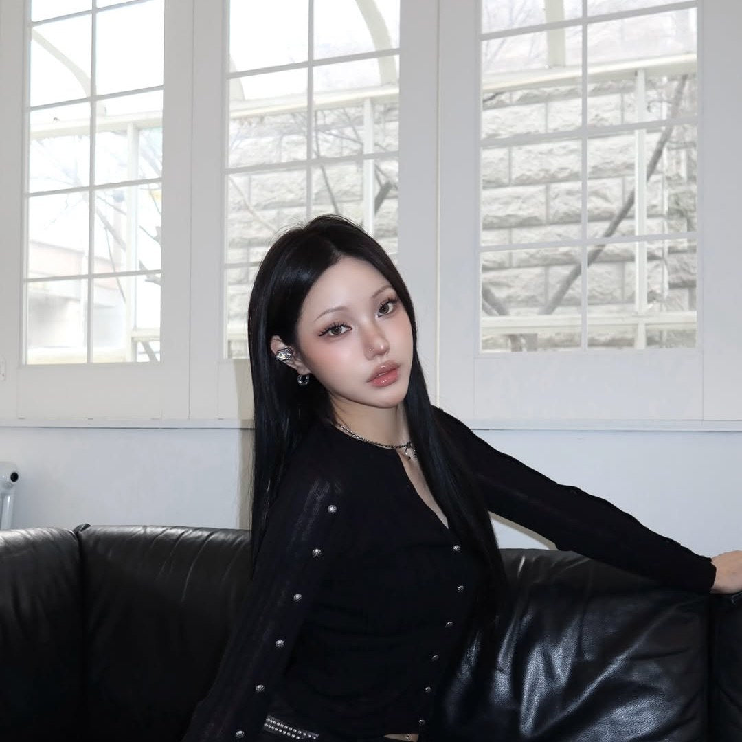 Electronic Gems worn with a black outfit beside a bright window.