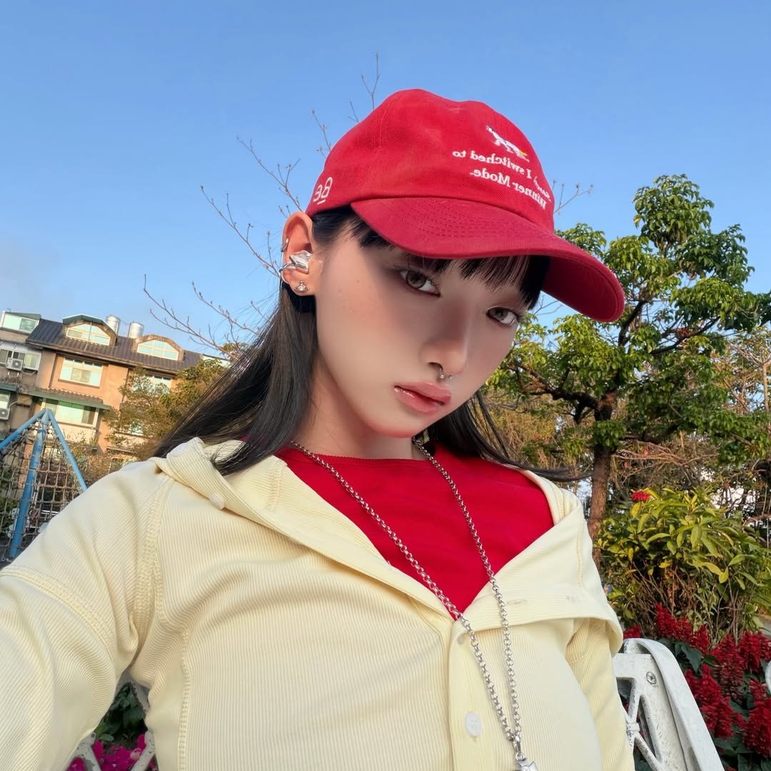 Electronic Gems paired with a red cap and pale yellow outer layer outdoors.