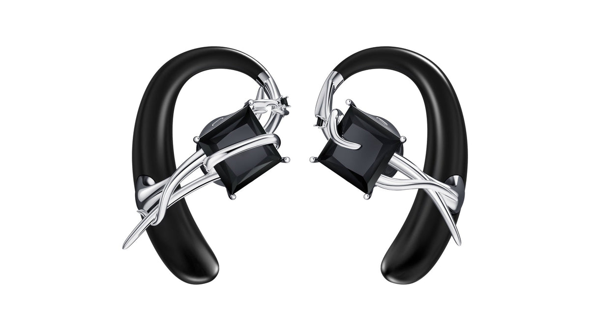 OF HUNGER MONOLITH open-ear accessory earphones with black geometric details on a clean white background.