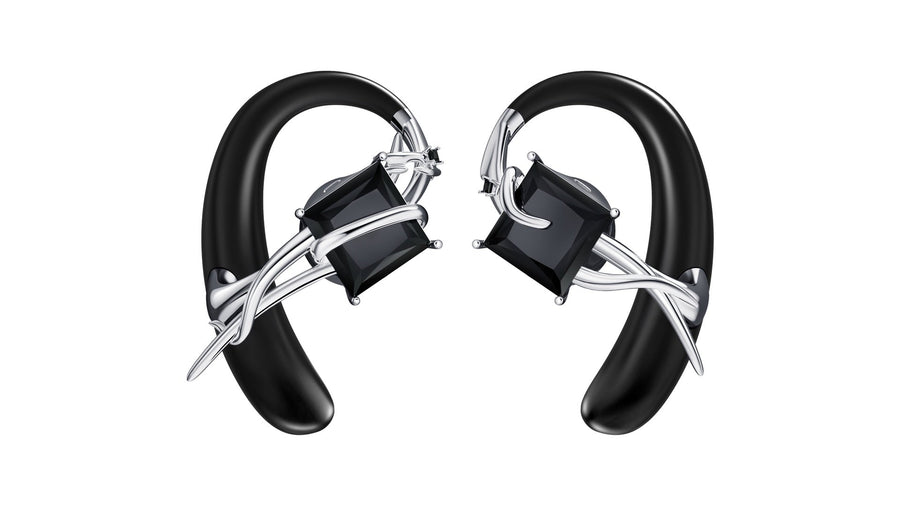 OF HUNGER MONOLITH open-ear accessory earphones with black geometric details on a clean white background.