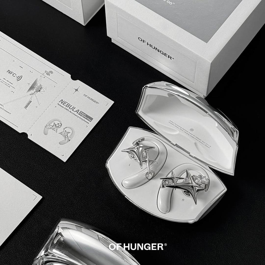 Pearl white NEBULA accessory earphones, case, card and packaging on black