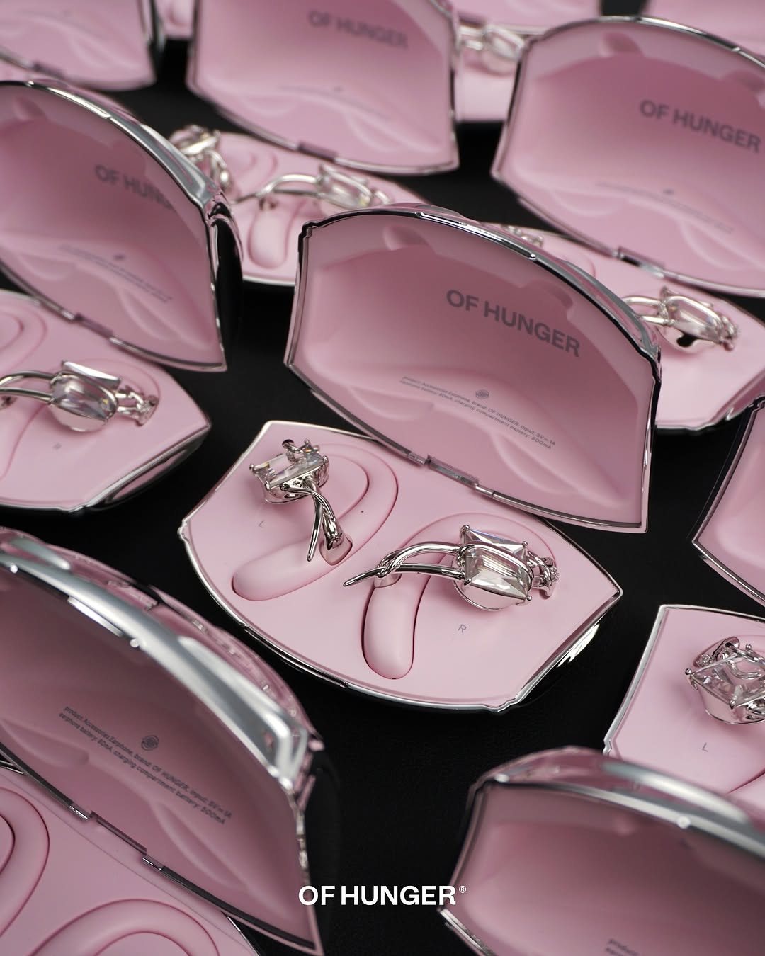Multiple silver accessory-earphone cases with vivid pink interiors