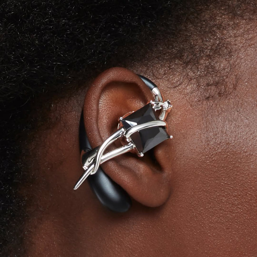 MONOLITH NEBULA accessory earphone with a black square stone on the ear