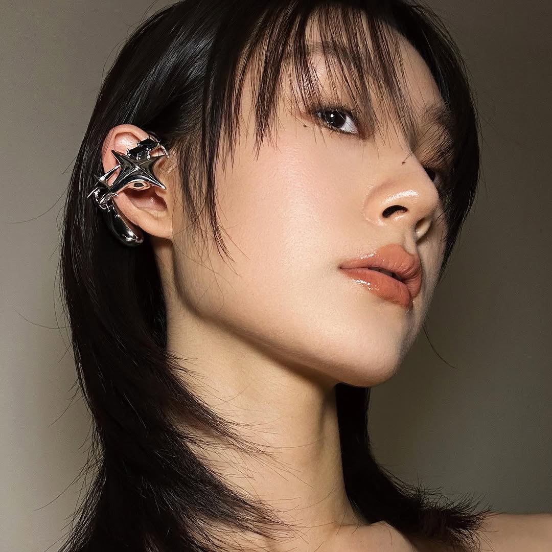 Model ZHE in profile wearing a silver star-like NEBULA ear form