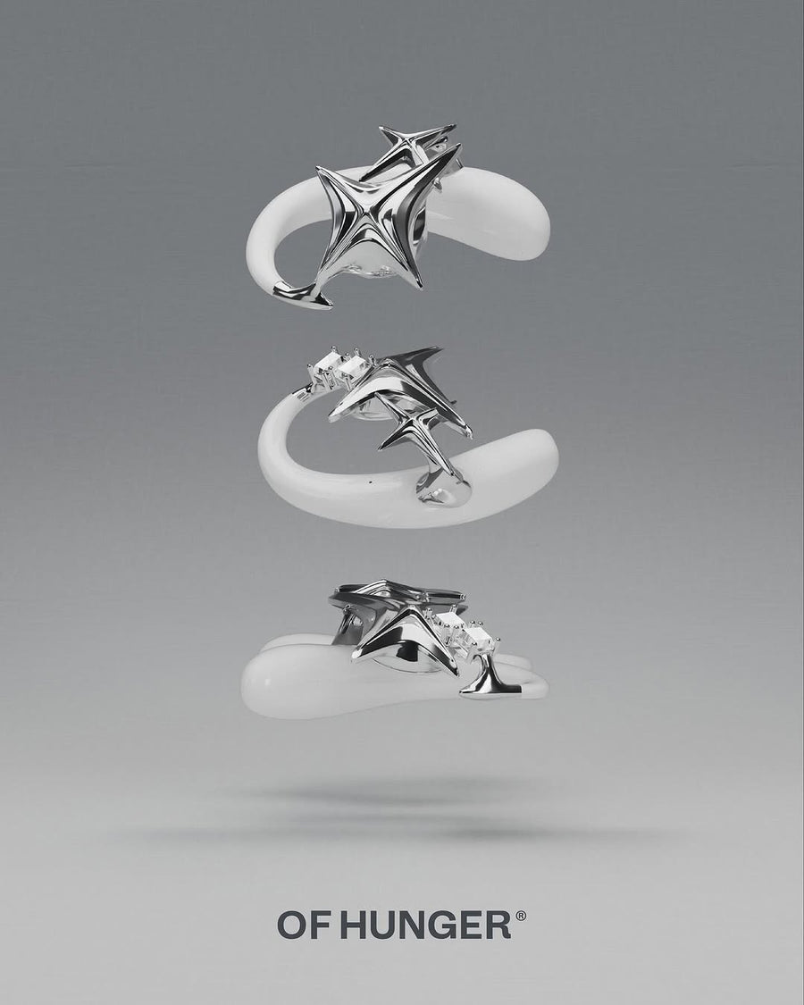 Three floating views of a white and silver star-like wearable object