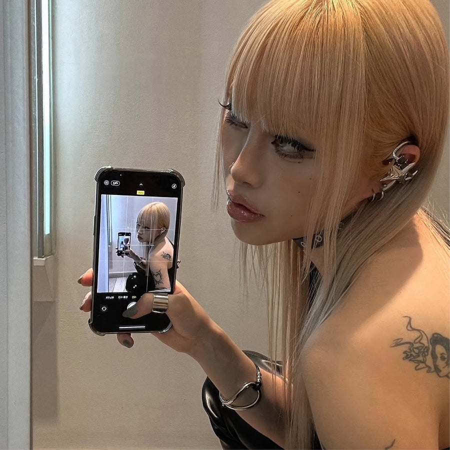 Blonde model Eunxx taking a mirror selfie while wearing NEBULA