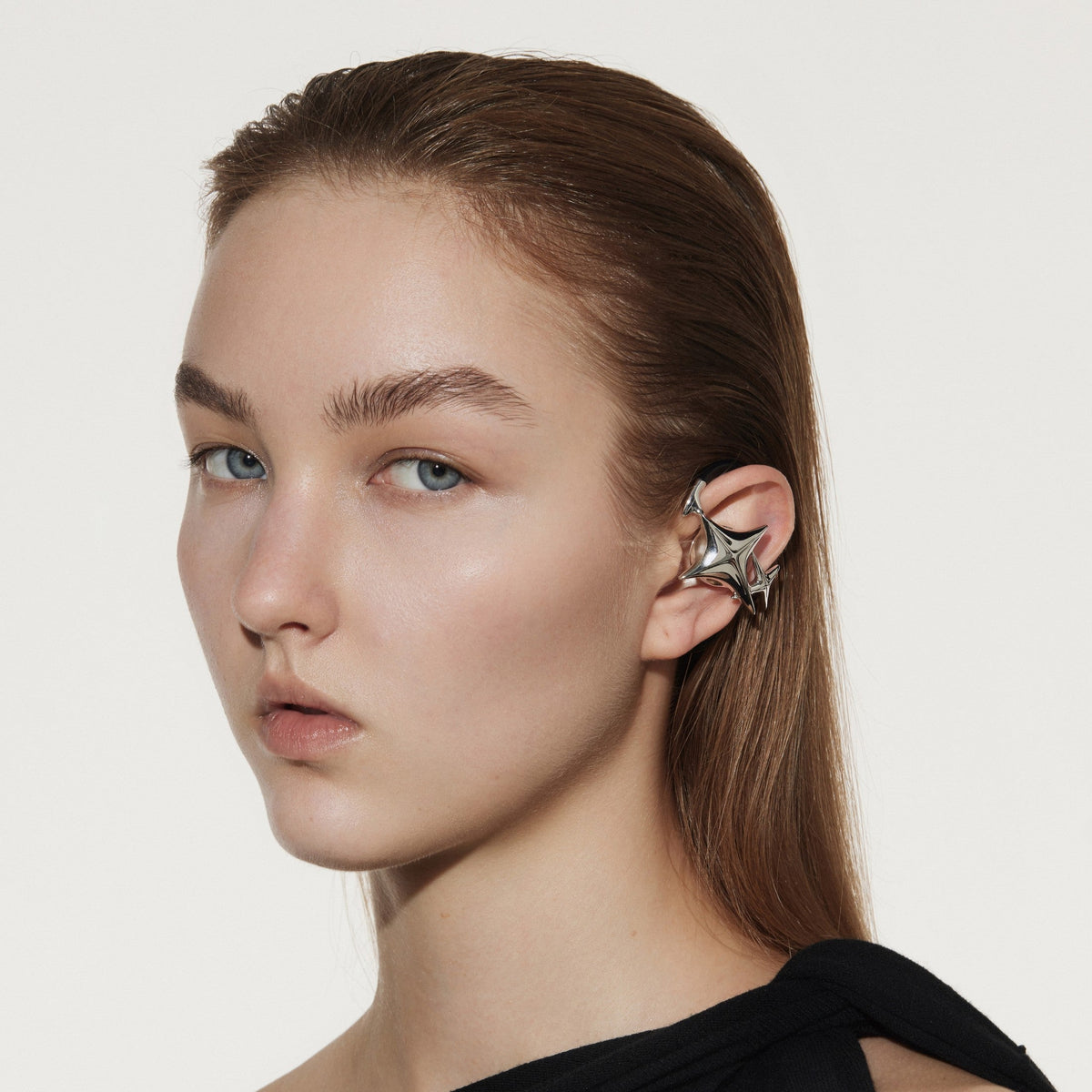 Model wearing sculptural OF HUNGER NEBULA earphones that read as a conversation-starting accessory