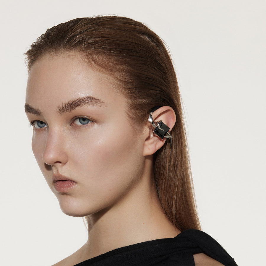 OF HUNGER black stone ear accessory worn on the body as visible electronic adornment