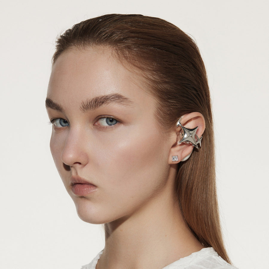 White OF HUNGER NEBULA earphones worn visibly as part of a fashion look