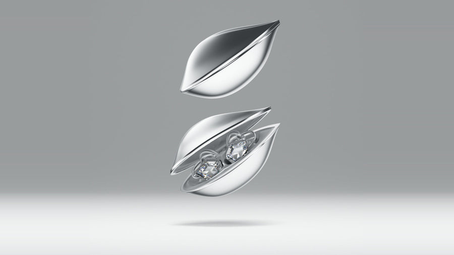 OF HUNGER Electronic Gems earphones displayed in a silver sculptural charging case